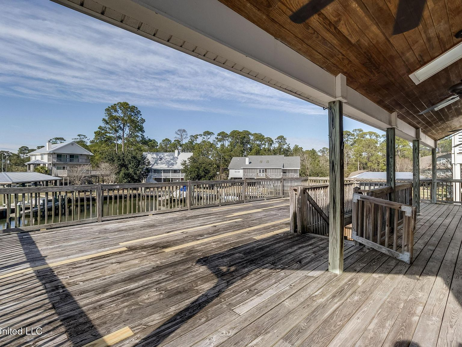 Covered wooden deck overlooking the waterfront canal