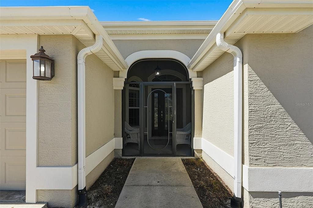 Screened front porch entryway with arched screen frame
