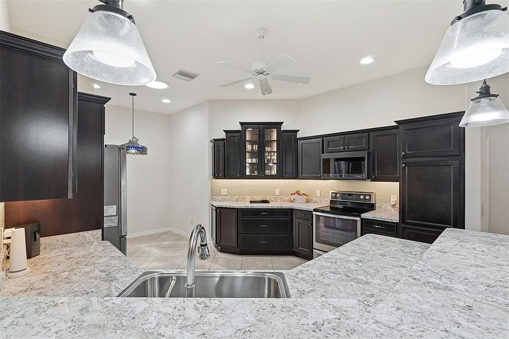 Kitchen with dark cabinetry and granite countertops