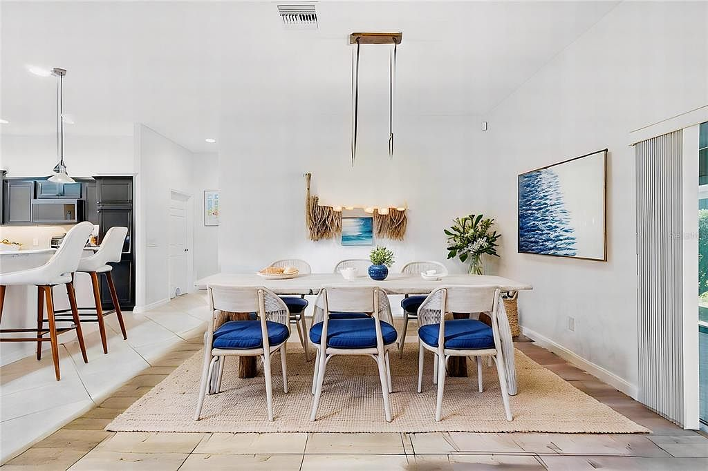 Dining area with sliding glass doors and wood-look flooring