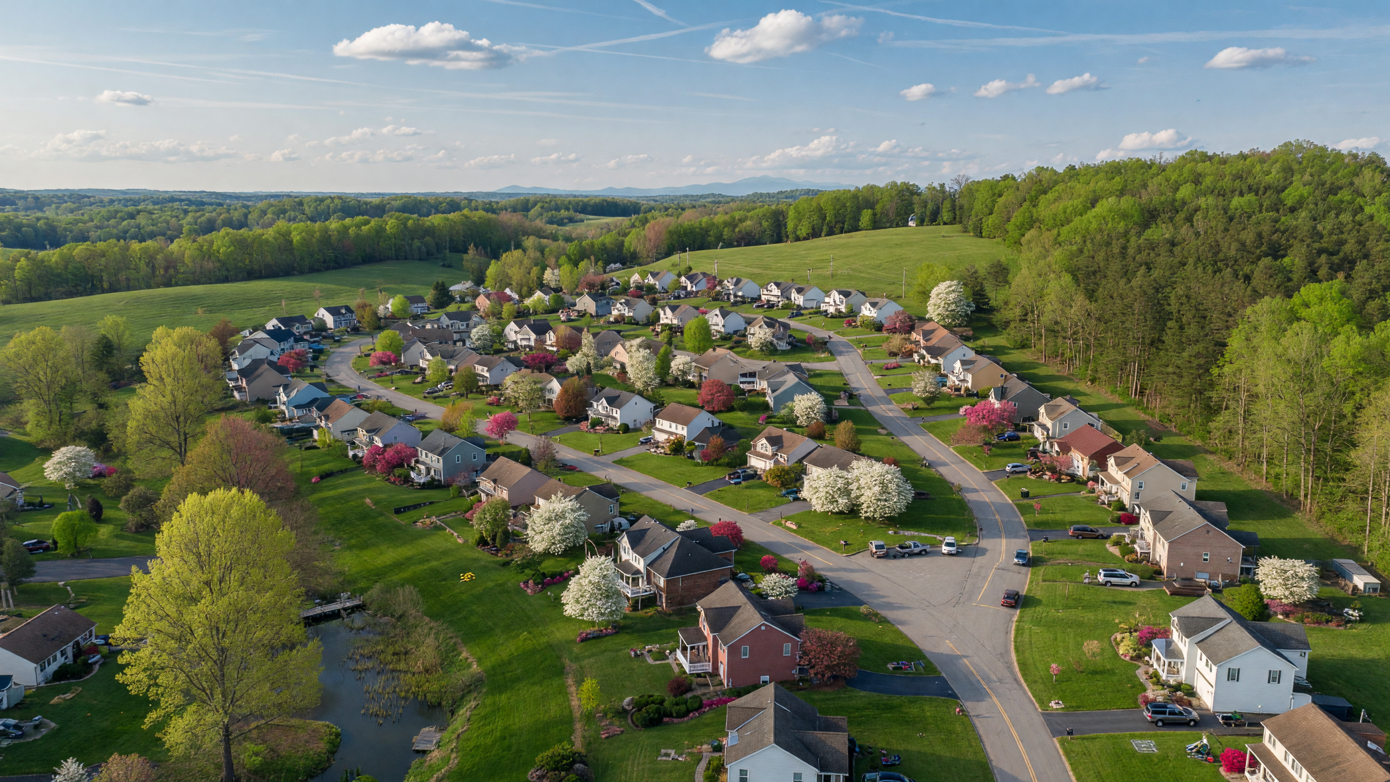 Parkridge neighborhood in Stafford Virginia — well-established community with mature trees, single-family homes, and winding residential streets on a bright spring afternoon