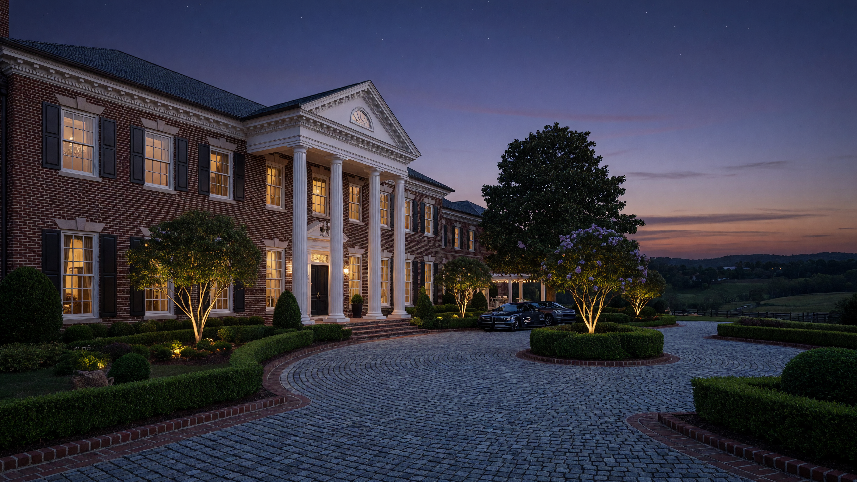 Elegant luxury brick estate home with grand columns at twilight in Virginia
