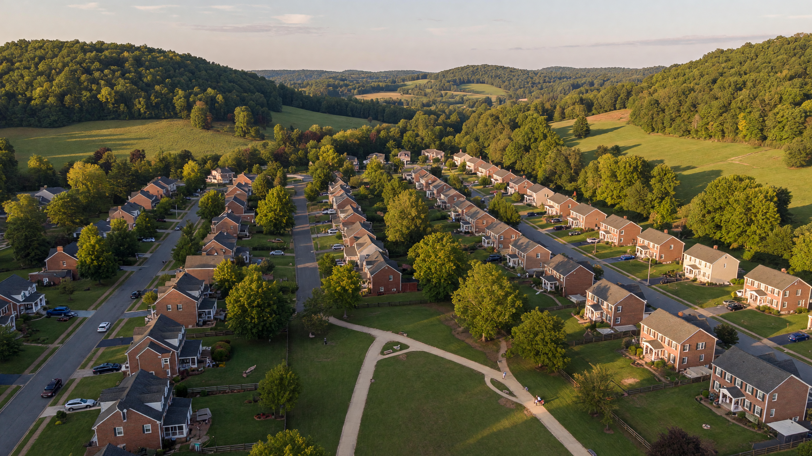 Aerial view of Stowe of Amyclae residential neighborhood in Stafford Virginia — colonial and traditional single-family homes with brick facades along tree-lined streets