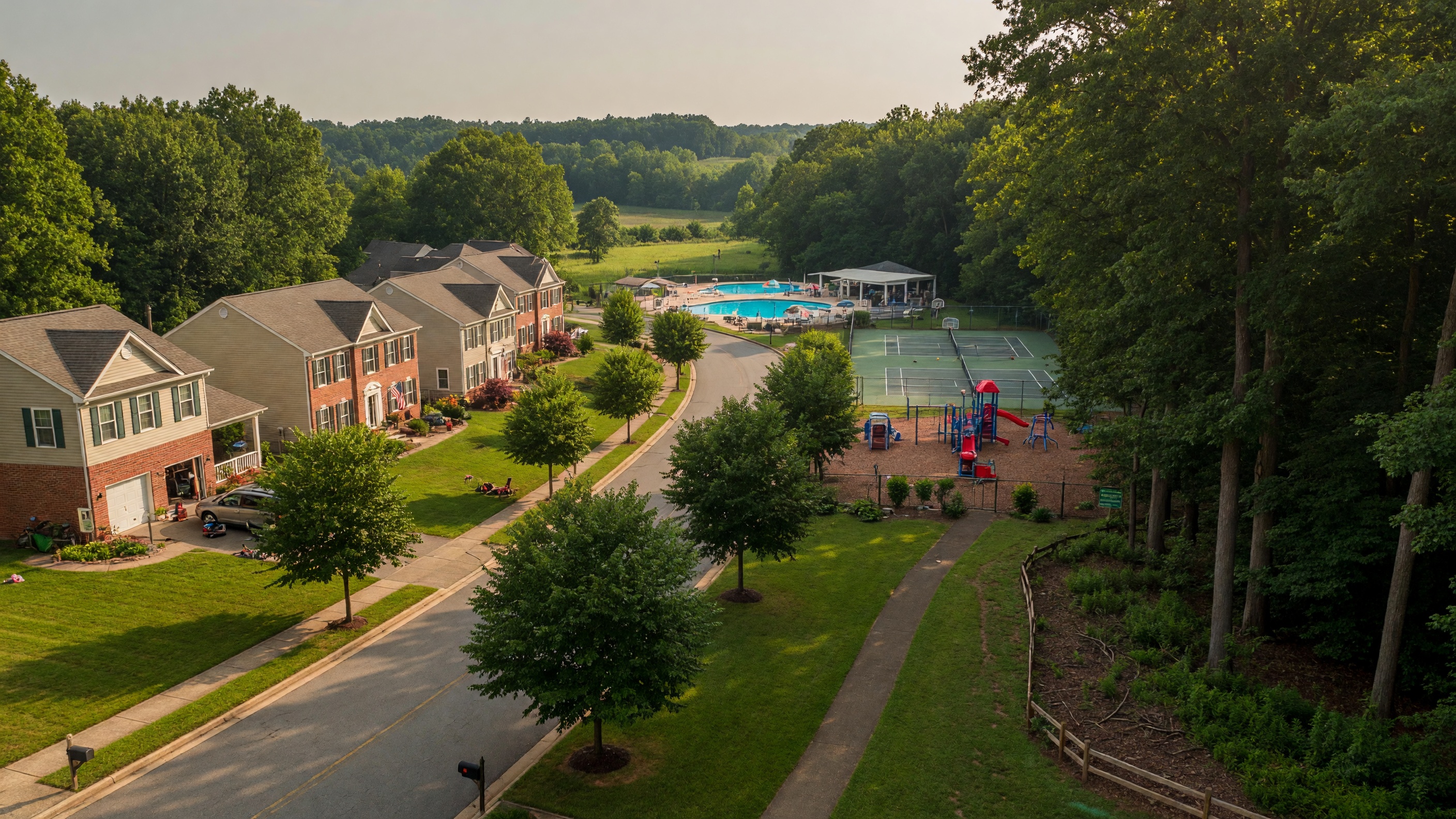 Chancellor West community in Spotsylvania County Virginia — peaceful tree-lined streets with traditional single-family homes, community pool, tennis courts, and playground surrounded by protected National Battlefield Trust woodland