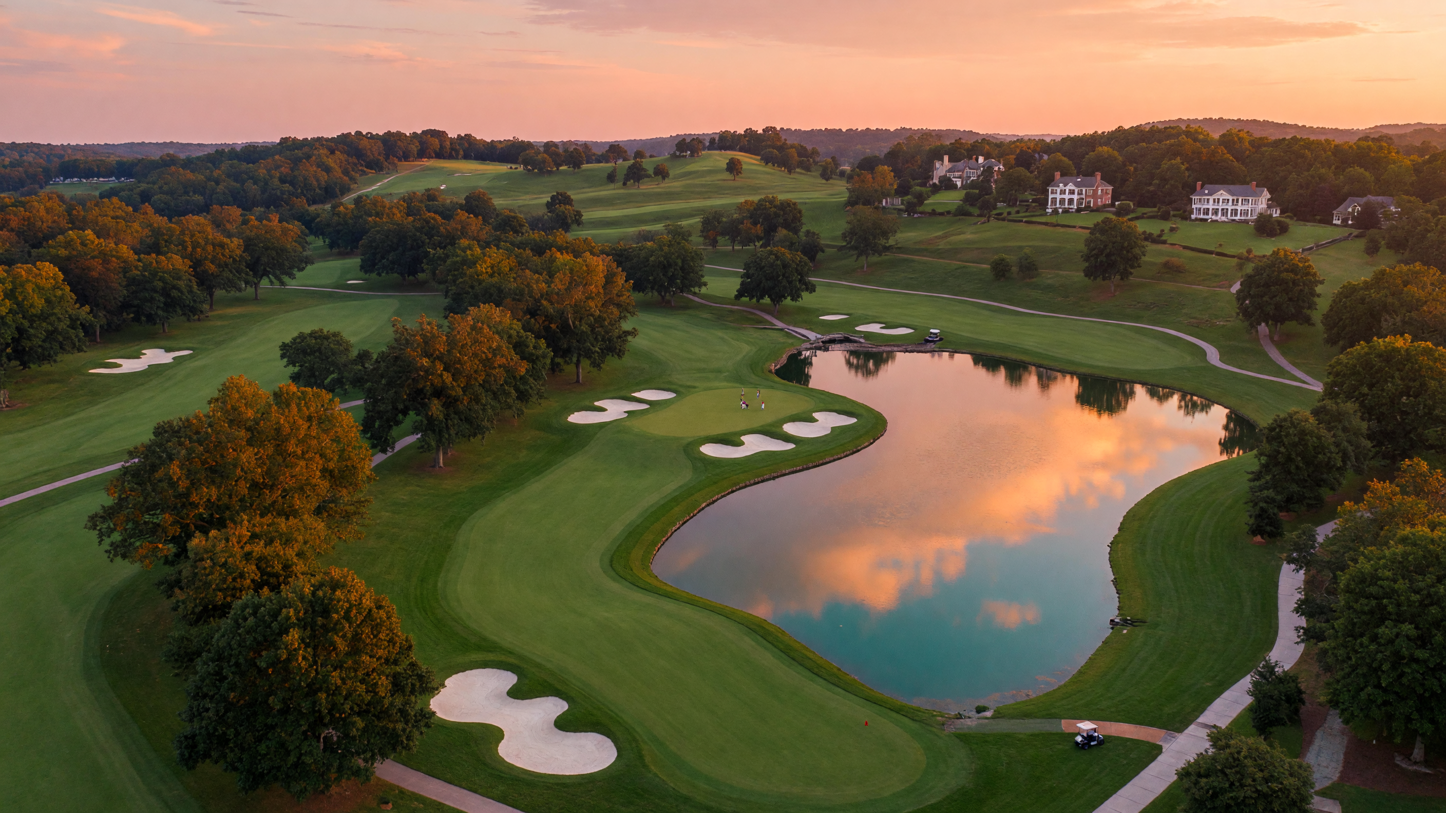 Championship golf course fairway winding through mature oaks in Virginia