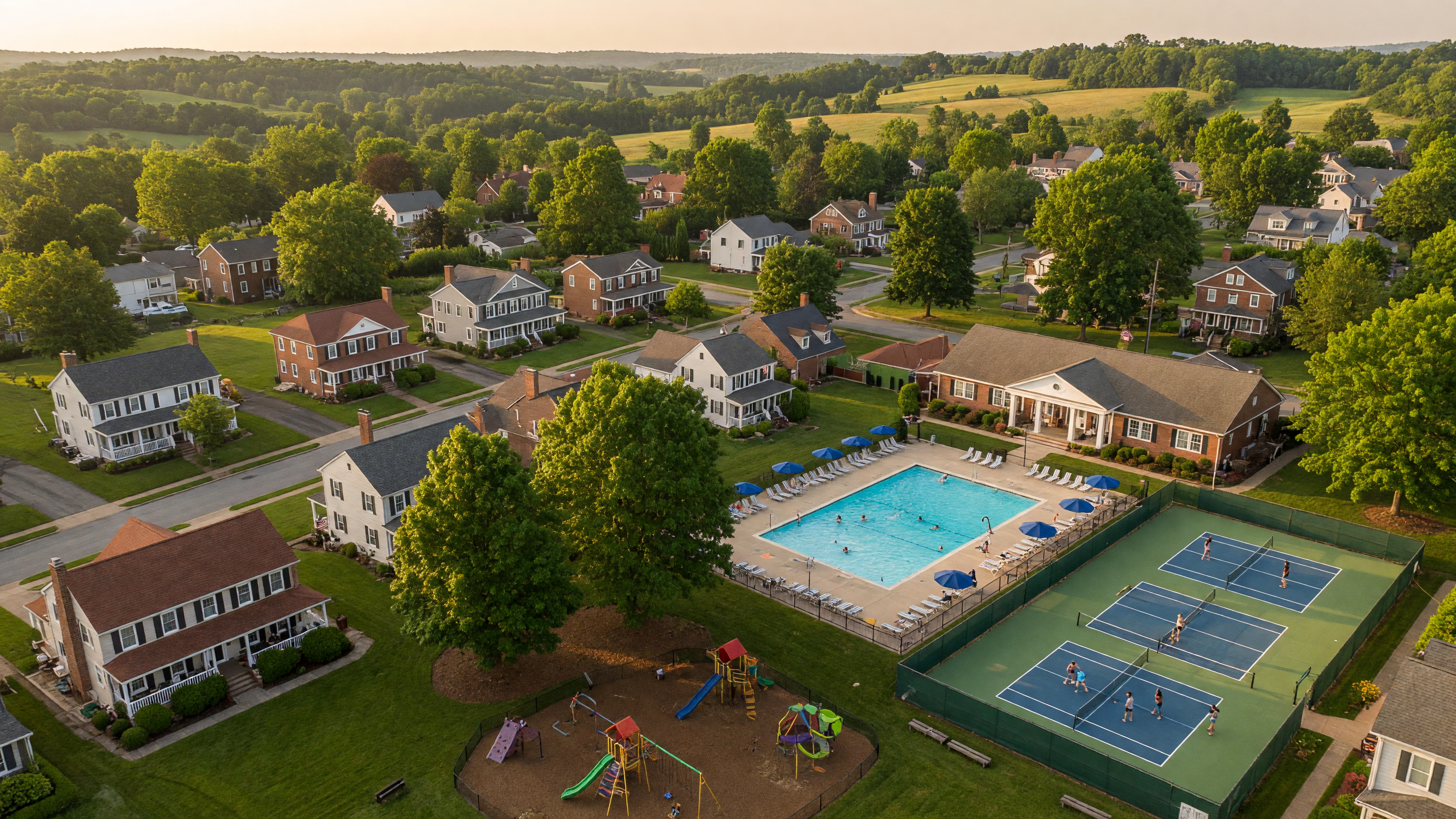 Fox Point neighborhood in Spotsylvania County Virginia — mature tree-lined streets, colonial and craftsman single-family homes, community swimming pool, tennis courts, and playground surrounded by rolling Virginia piedmont landscape