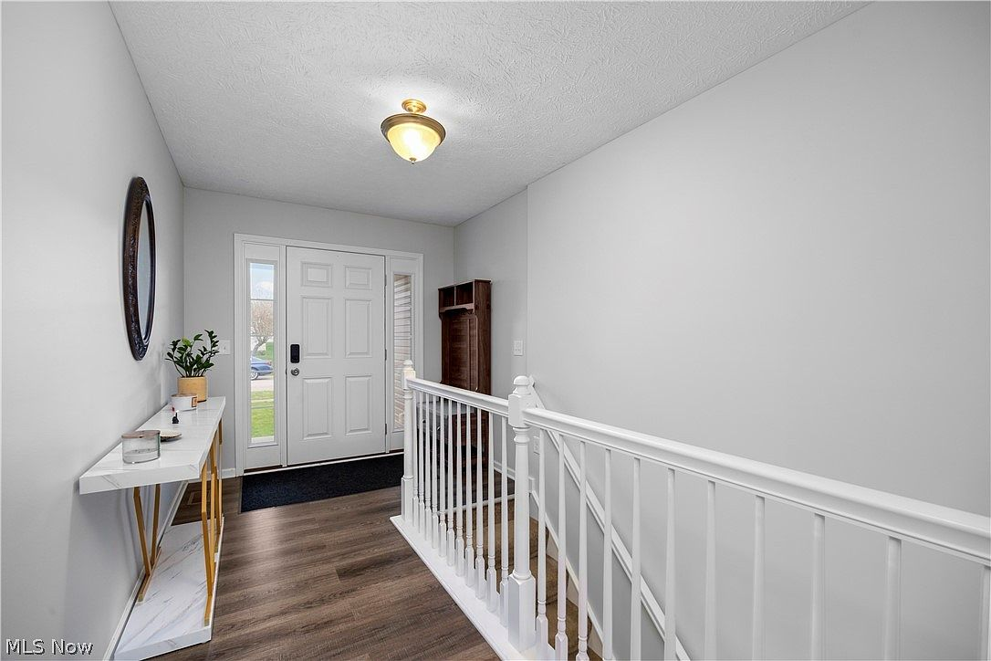 Interior entryway with front door and staircase