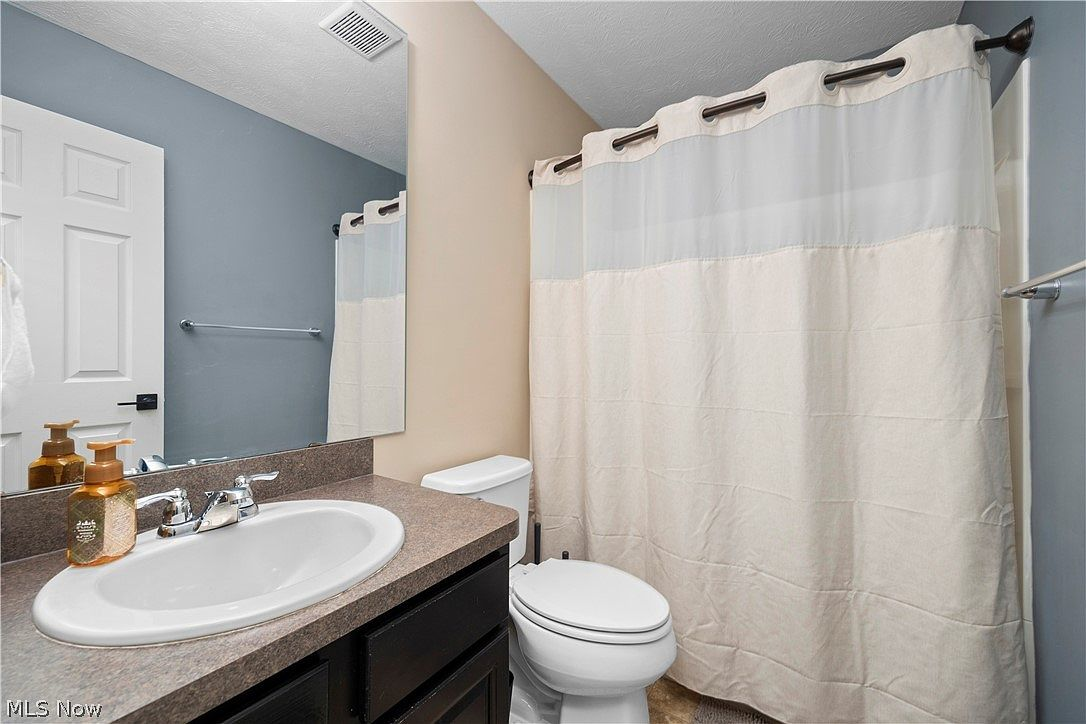 Bathroom with dark wood vanity and chrome fixtures