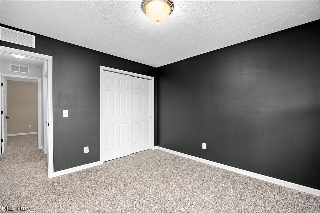 Bedroom with dark charcoal accent walls