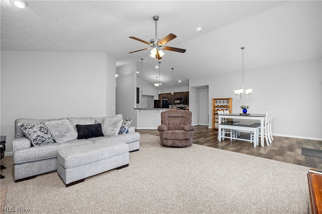 Open floor plan connecting living, dining, and kitchen areas