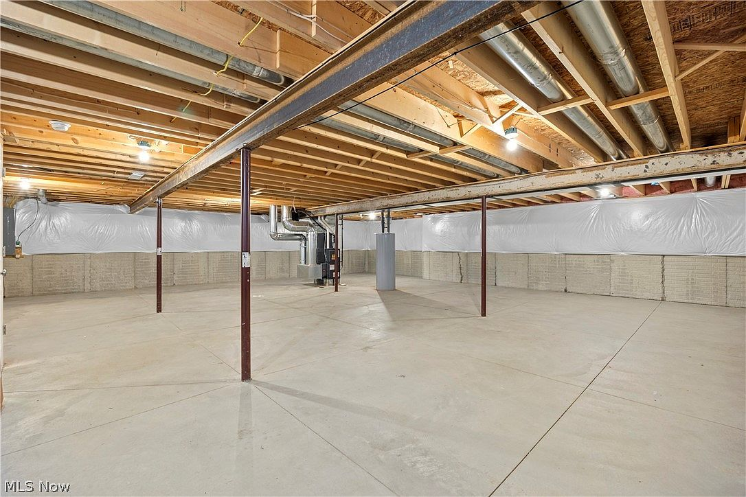 Large unfinished basement with concrete floors and block walls
