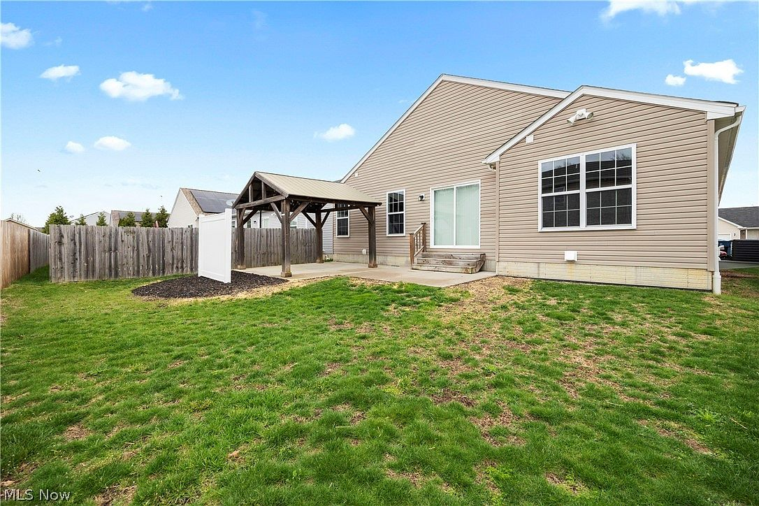 Backyard pergola and patio from lawn view