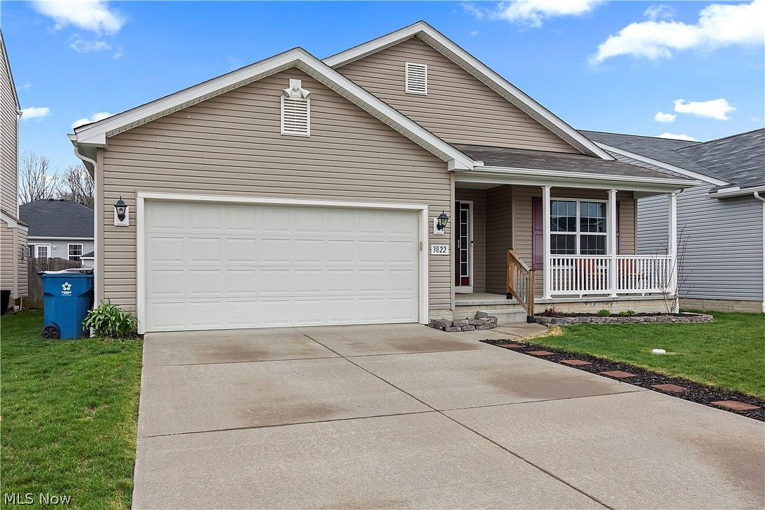 Front exterior with driveway and two-car garage