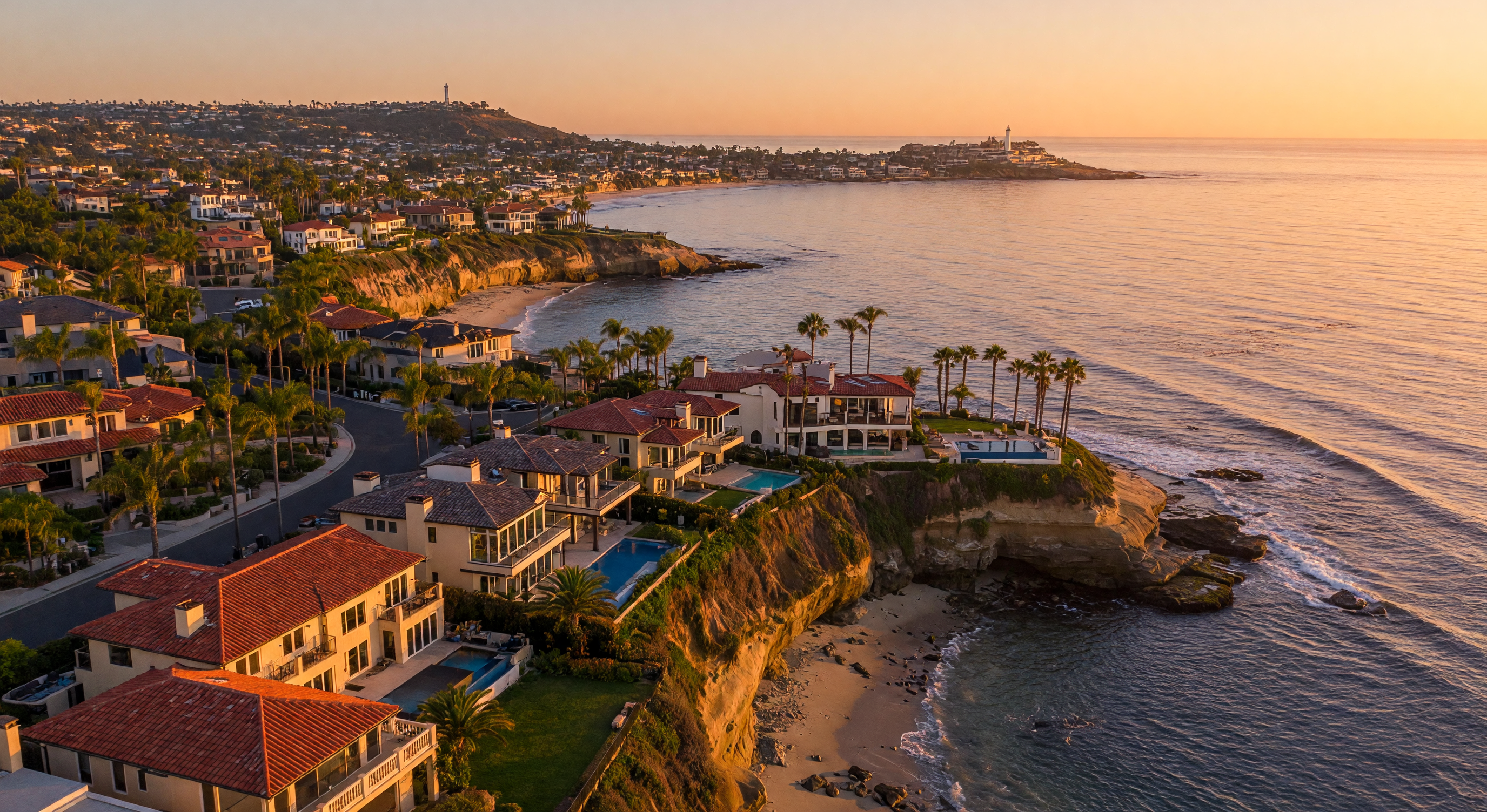 San Diego coastline with luxury homes along the Pacific bluffs at golden hour