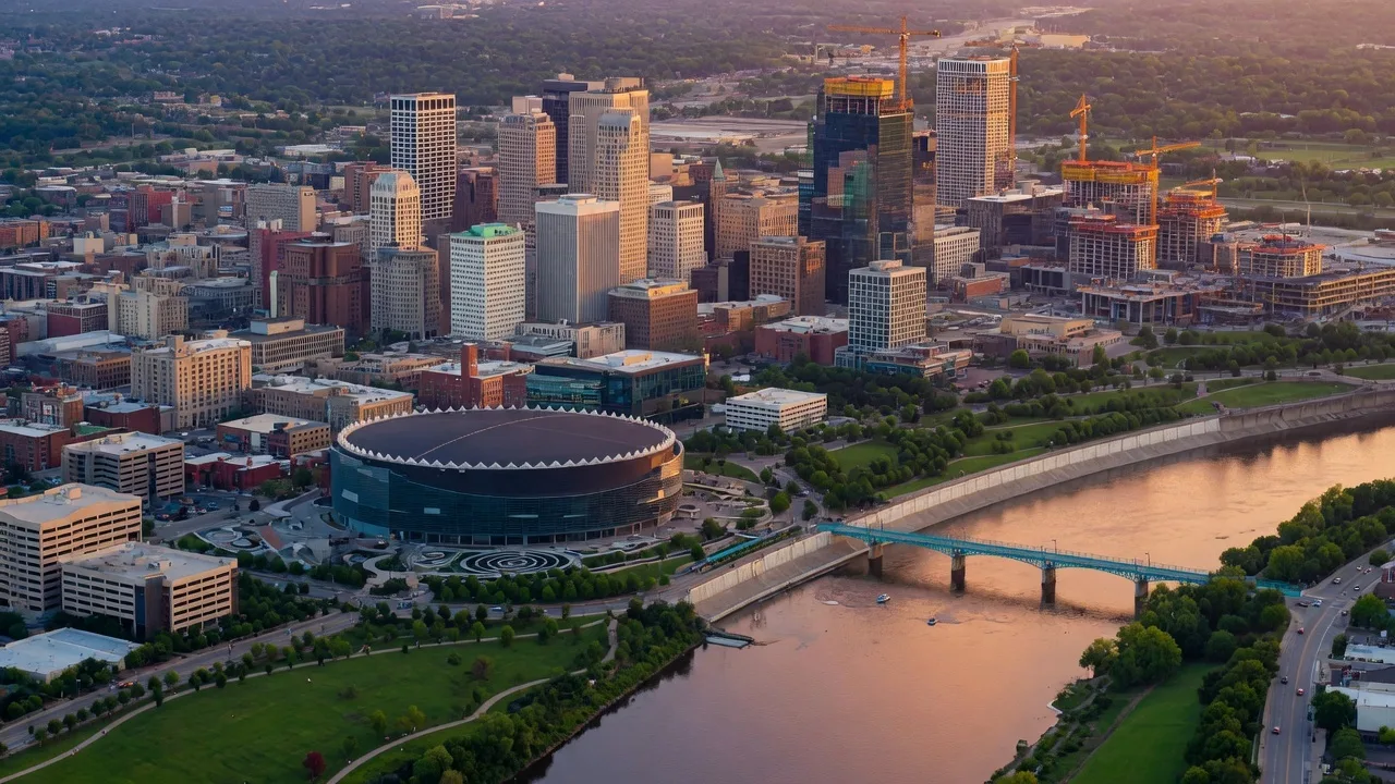 The Tulsa skyline at golden hour with new construction and the Arkansas River in view