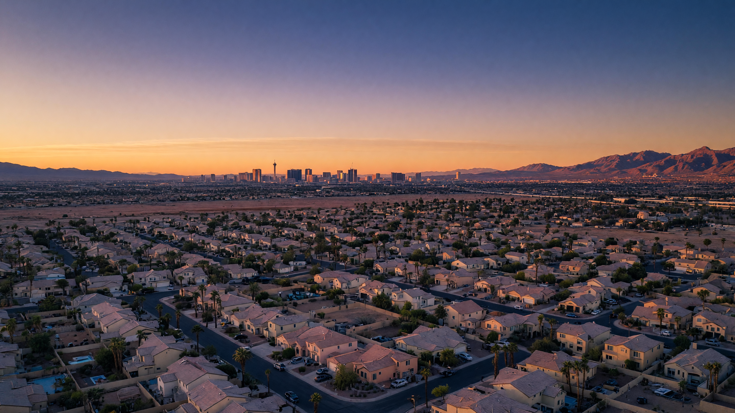 Aerial view of Las Vegas suburban neighborhoods at dawn stretching toward the Strip skyline