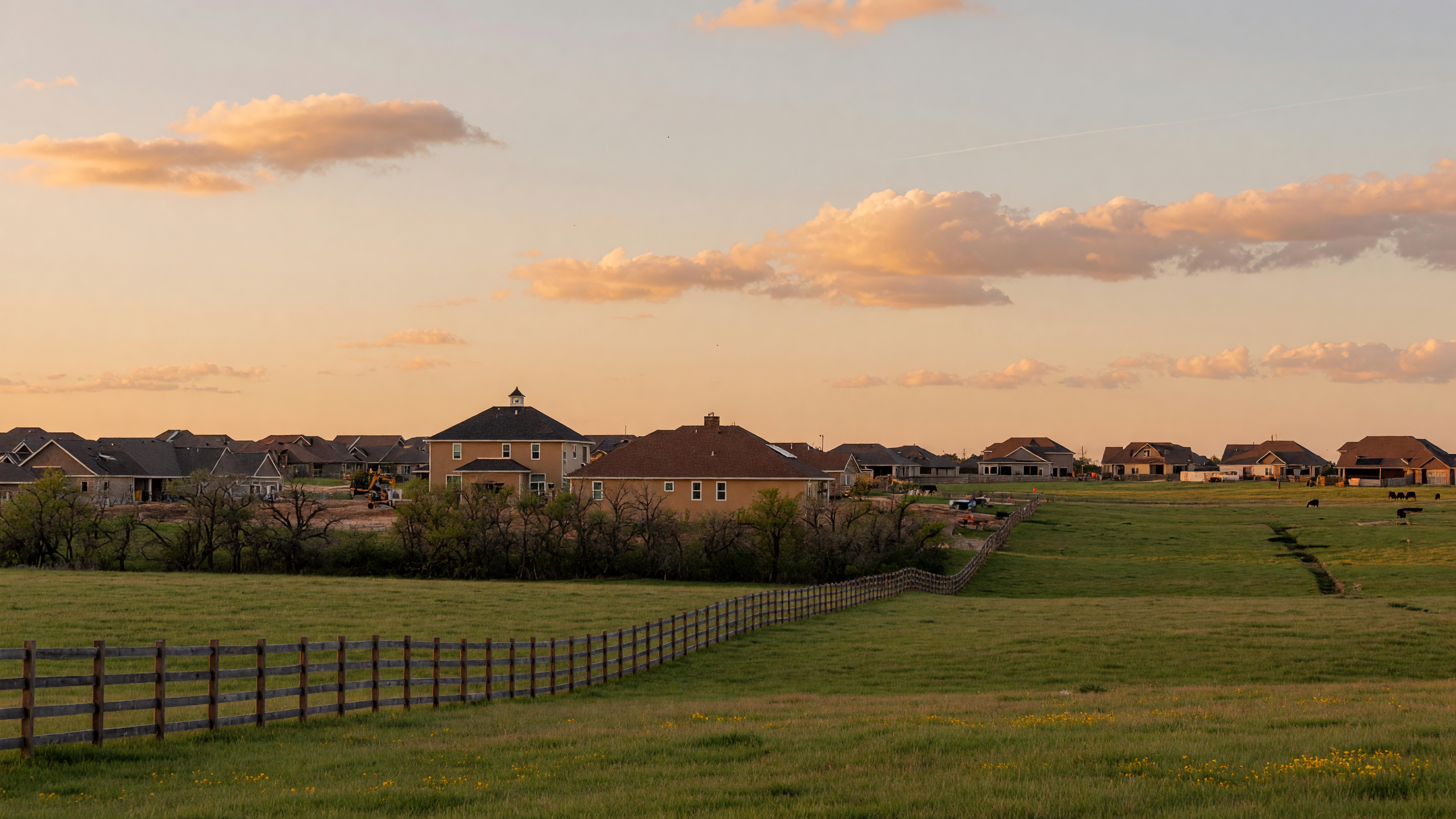 Rolling countryside and new residential communities in Justin, Texas, open pastureland meeting modern suburban development in Denton County