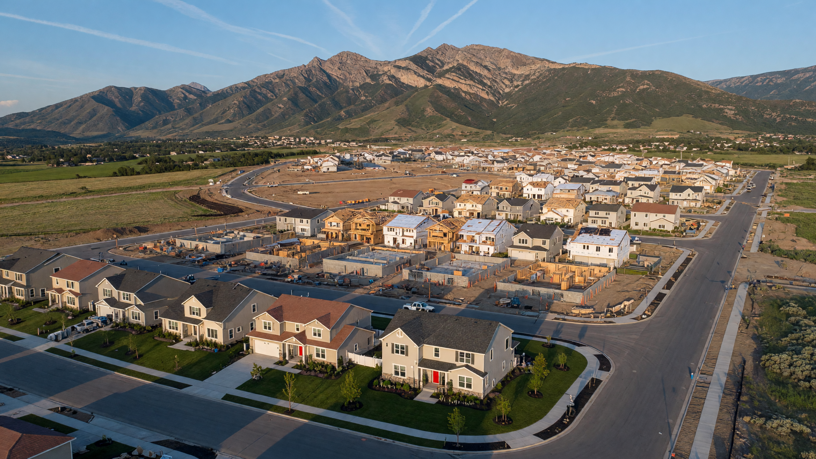 Modern model home interior with open-concept kitchen and mountain views in a Utah new construction home