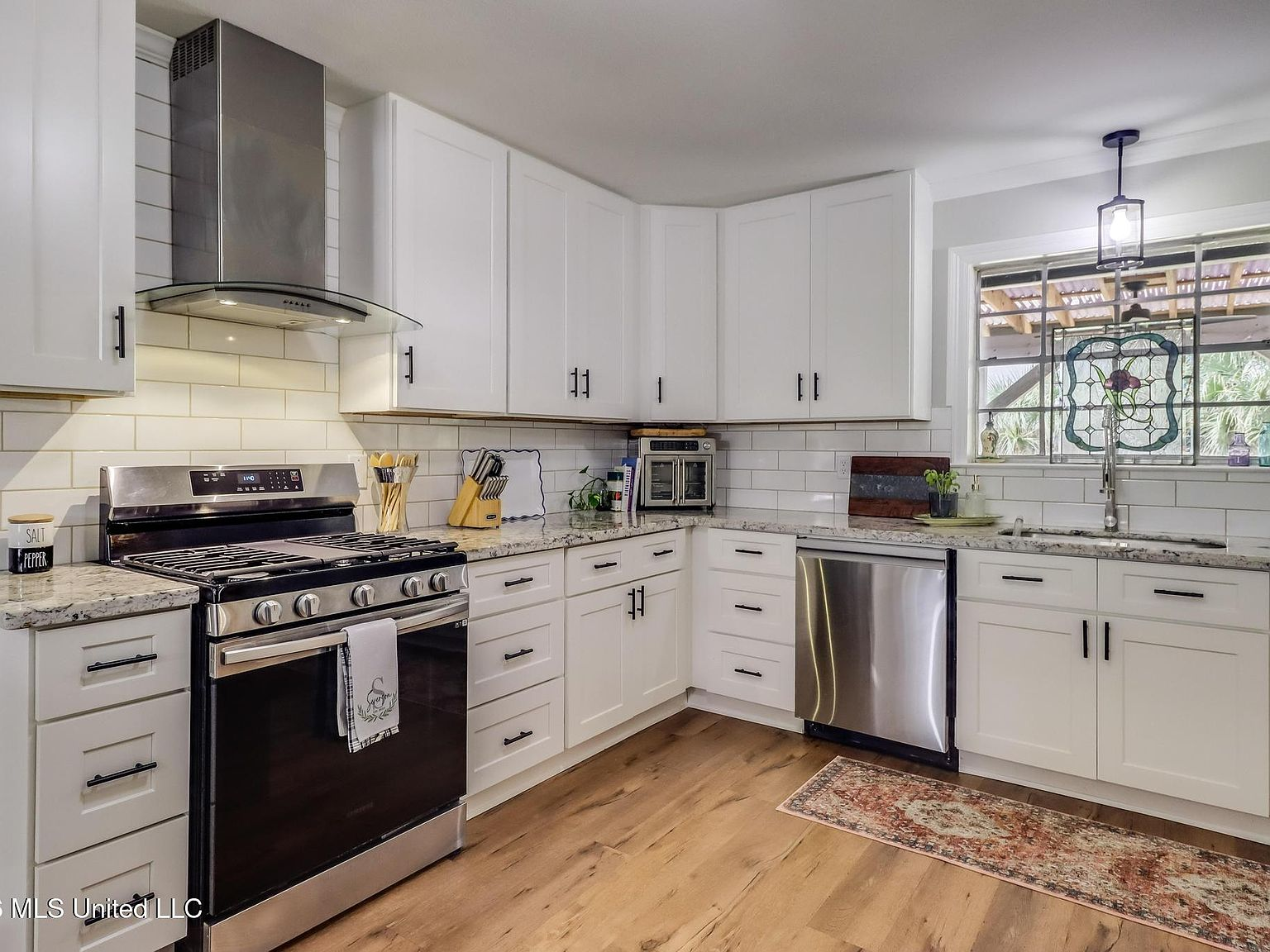 Kitchen close-up showing granite countertops and white subway tile backsplash