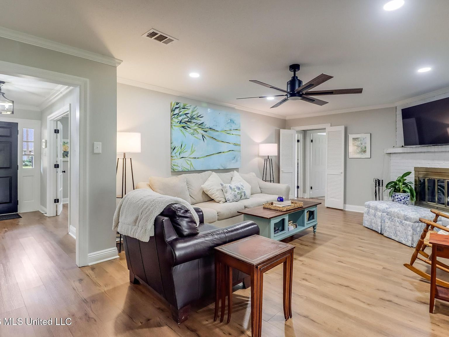 Wide-angle view of the living room with fireplace and warm lighting