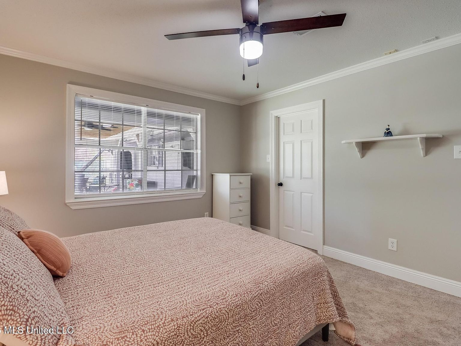 Secondary bedroom with ceiling fan and beige carpet
