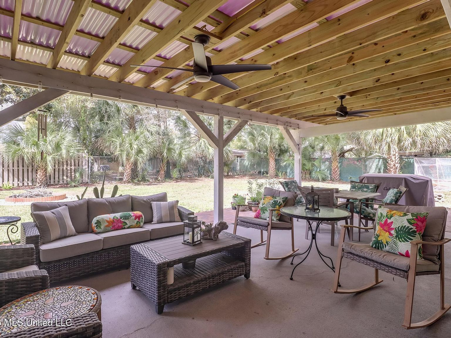 Covered patio with wooden beams and outdoor seating area