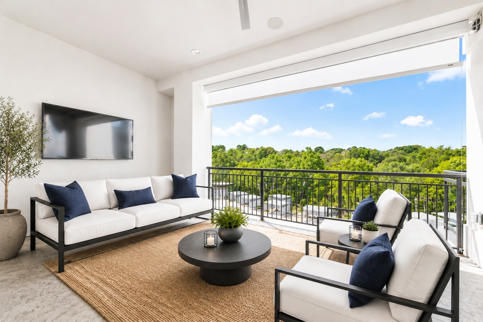 Covered lanai balcony with white-cushioned sofa, navy throw pillows, potted olive tree, and views of Lake Norman