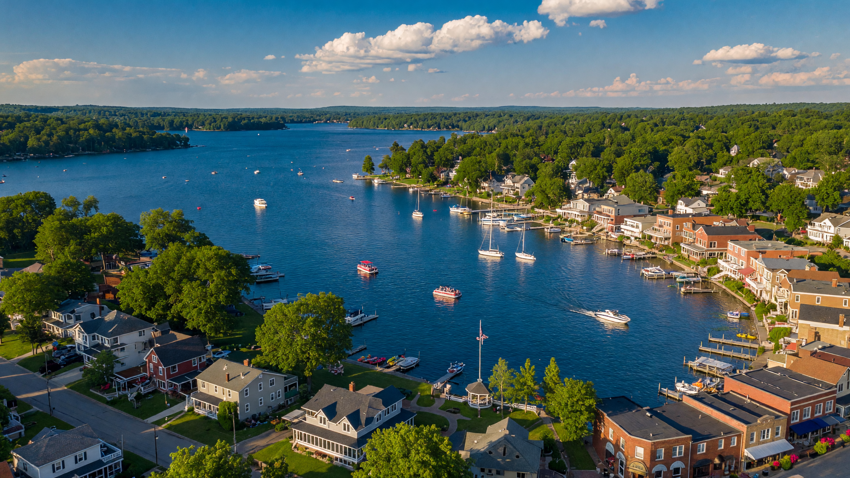 An aerial view of Lake Orion Michigan showing the sparkling lake, charming downtown, and tree-lined neighborhoods