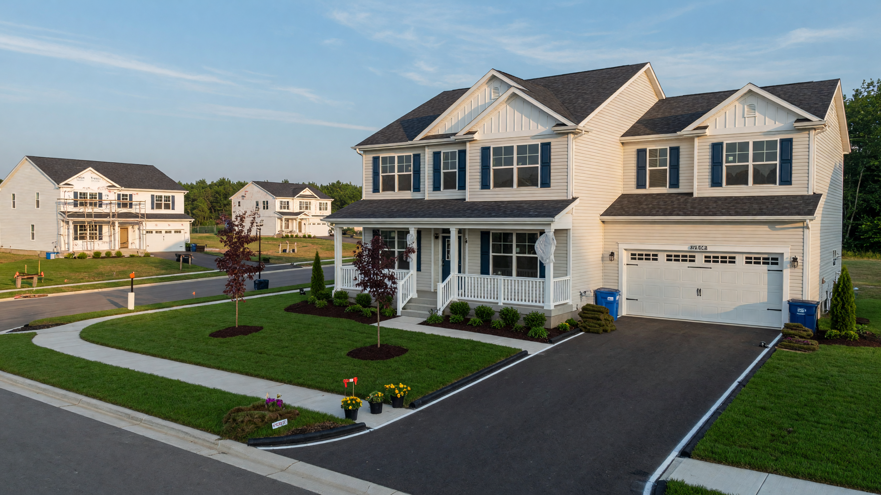 New construction home in a Mid-Michigan neighborhood with modern architecture, fresh landscaping, and a clear blue sky