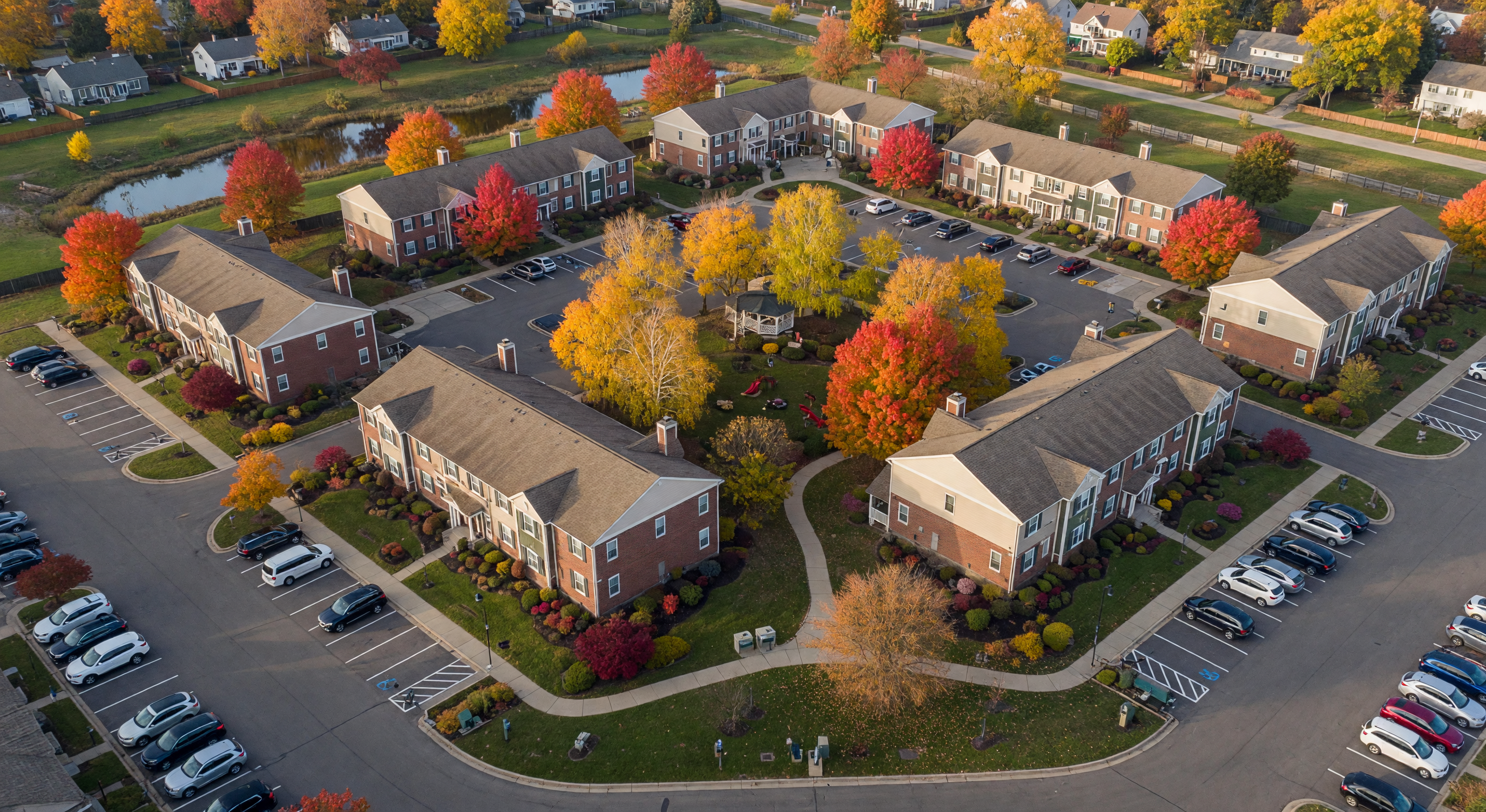 Aerial view of condominium community in suburban Michigan with autumn foliage