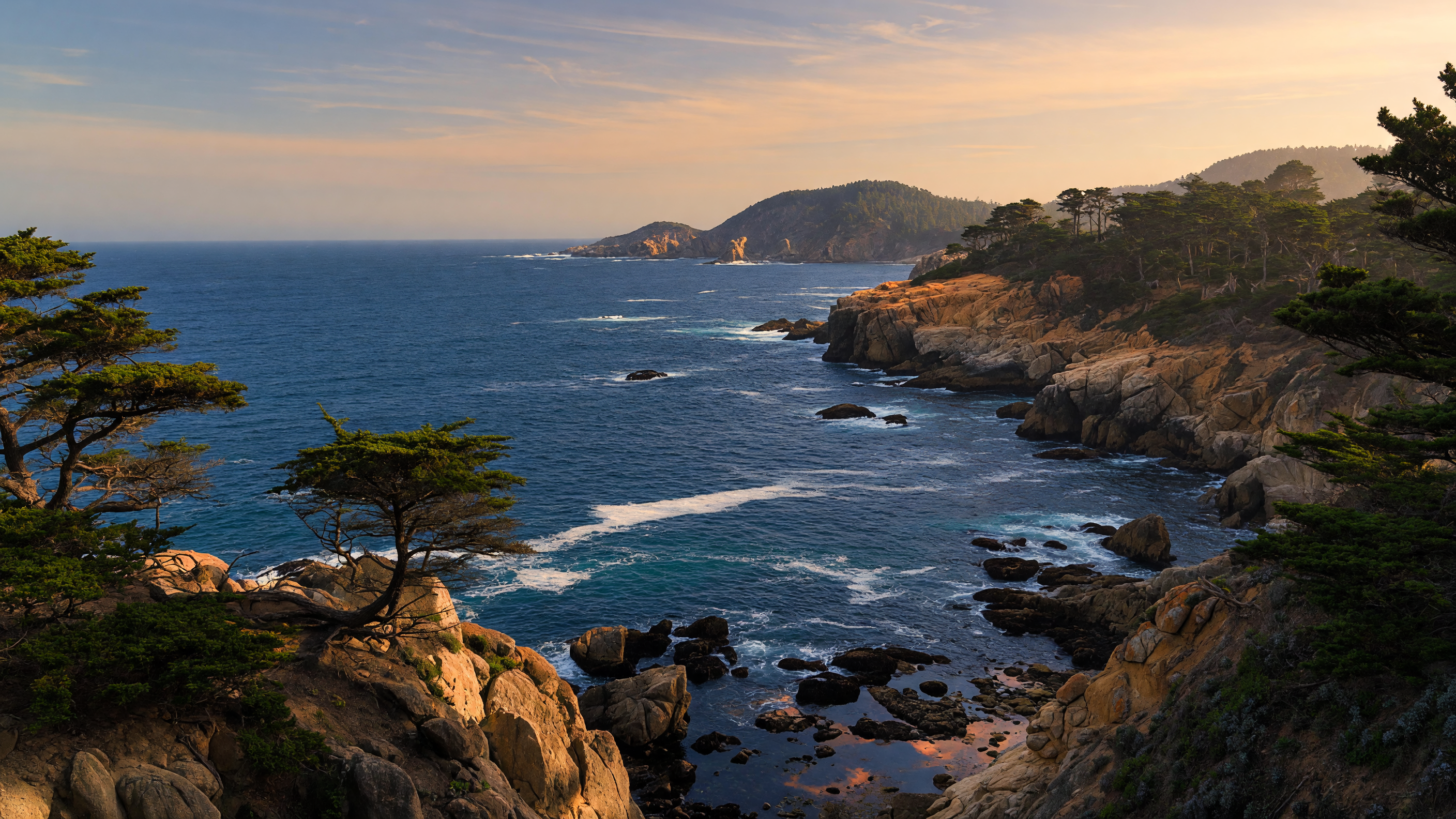 Sunlit coastal bluff overlooking the Monterey Bay coastline with cypress trees and rocky Pacific shore