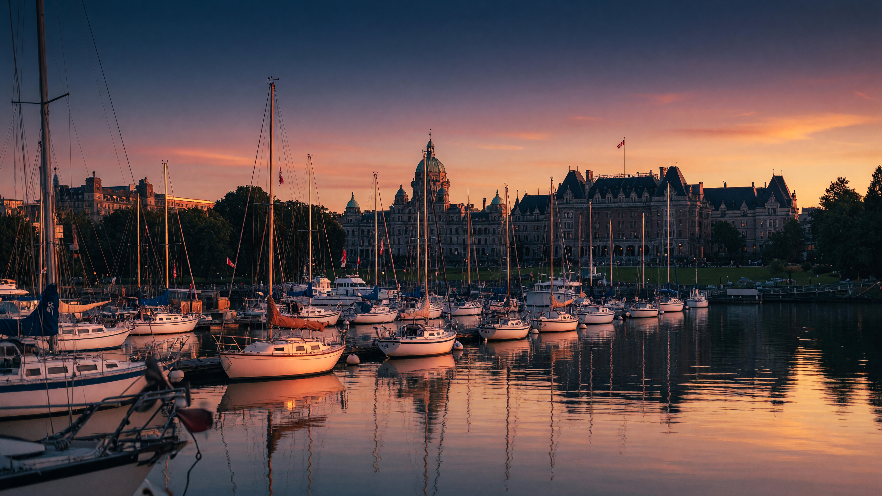 Sailboats moored in Victoria Inner Harbour at sunset