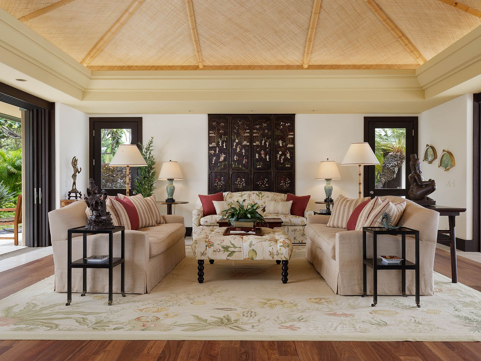 Great Room interior with woven lauhala vaulted ceiling, rich wood framing, and ocean-facing pocket doors