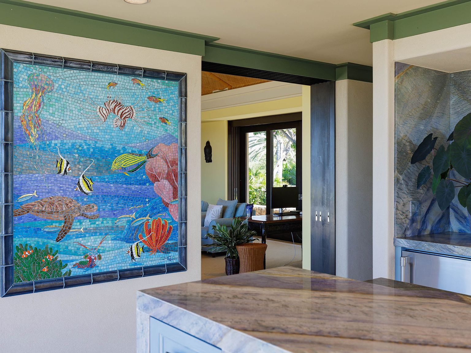 Interior with custom sea life mosaic mural, stone countertops, and green trim