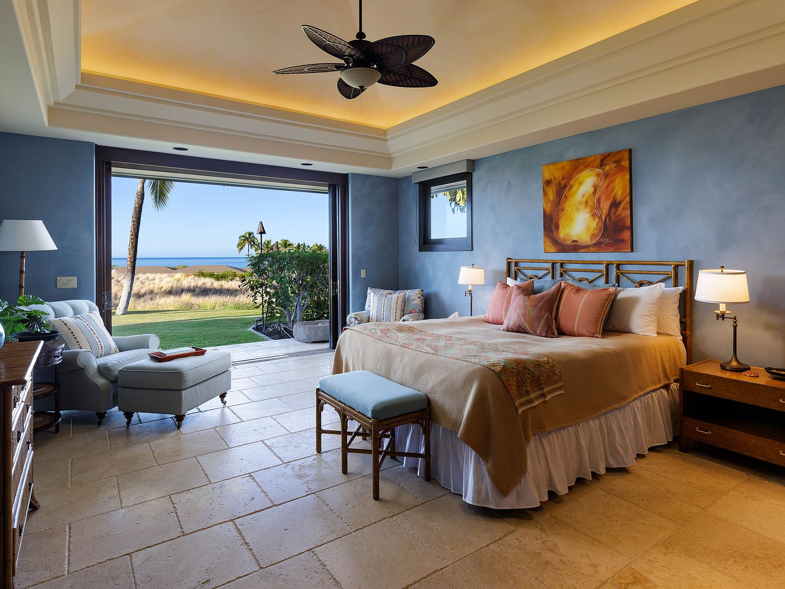 Primary suite with fully retracted pocket doors opening to lawn and ocean