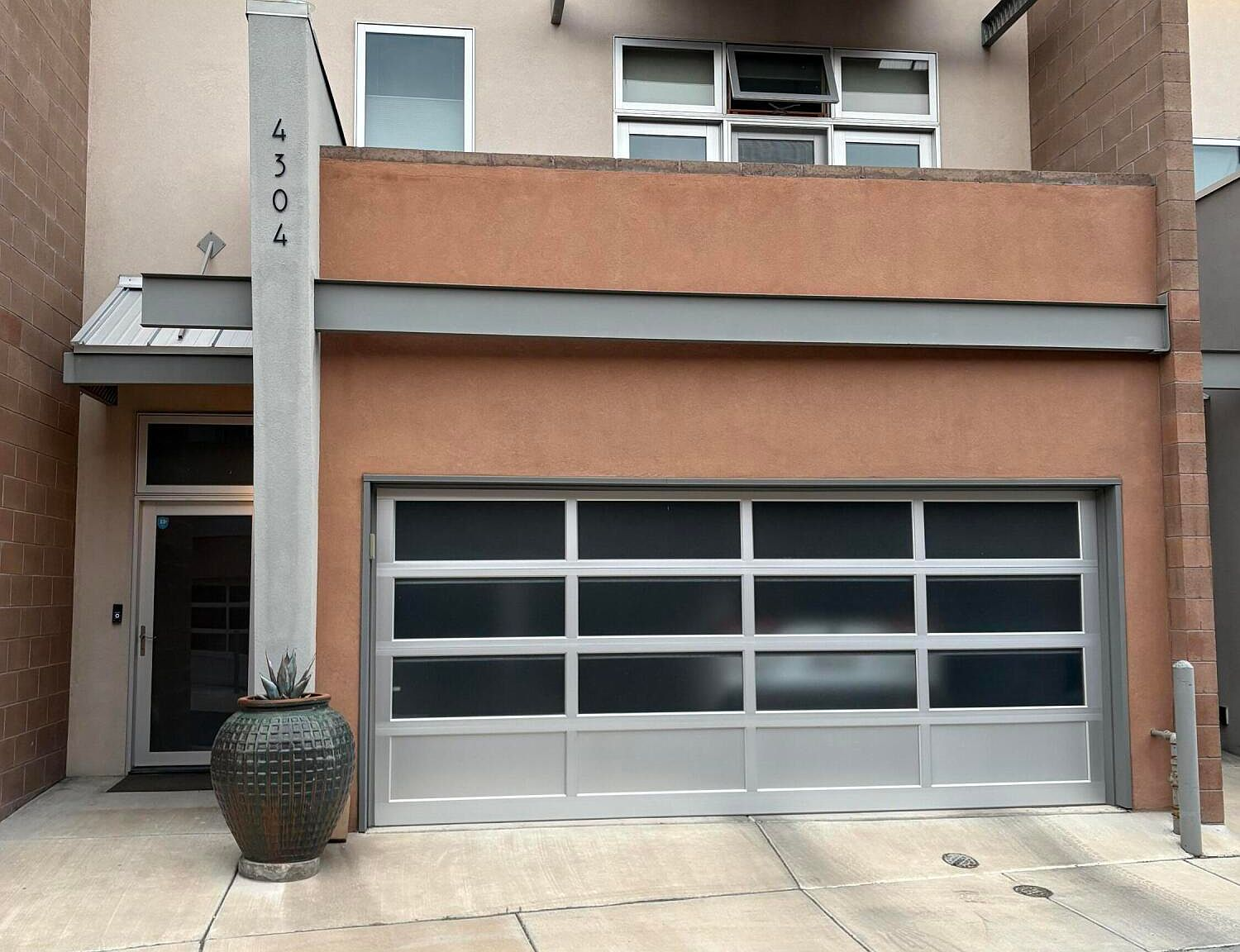 Close-up of townhome entrance and garage with steel beams