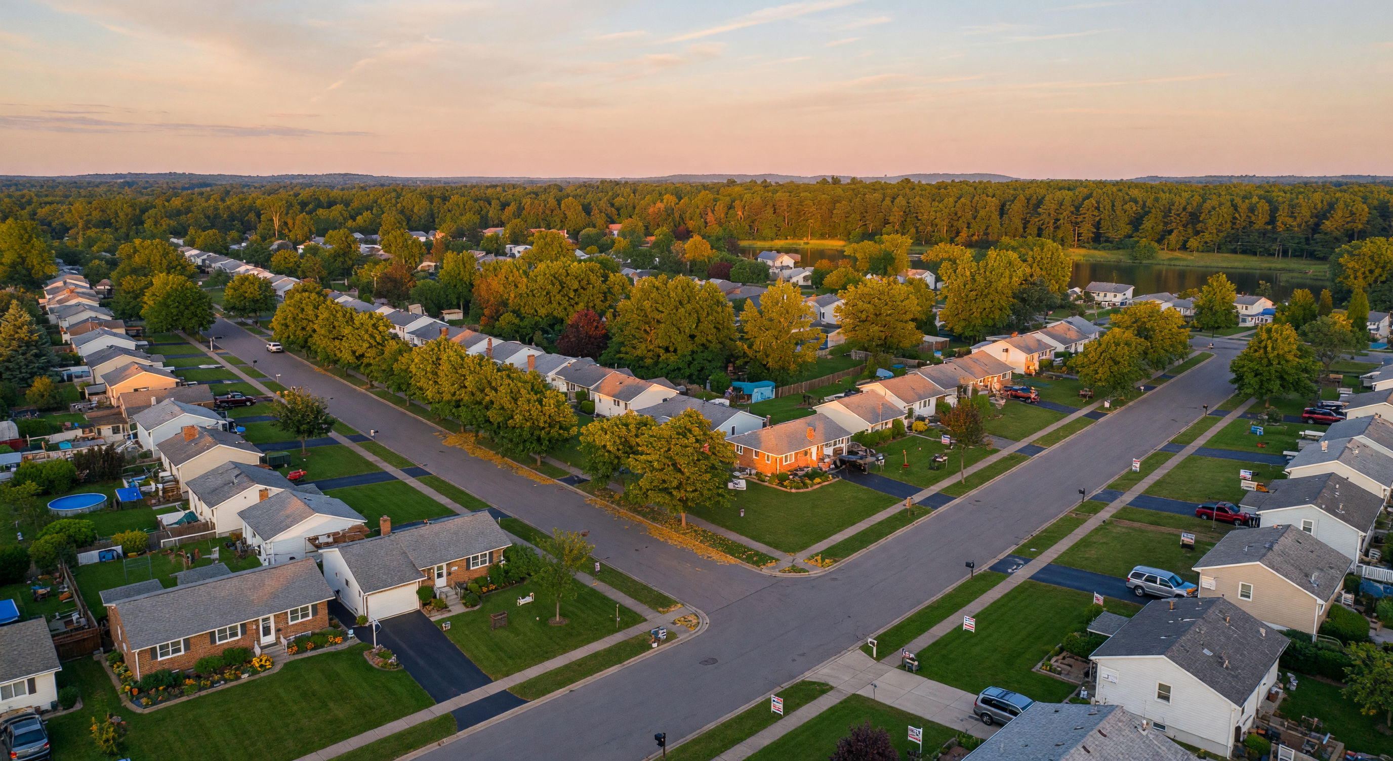 Pleasant green suburban Michigan neighborhood at warm summer golden hour sunset