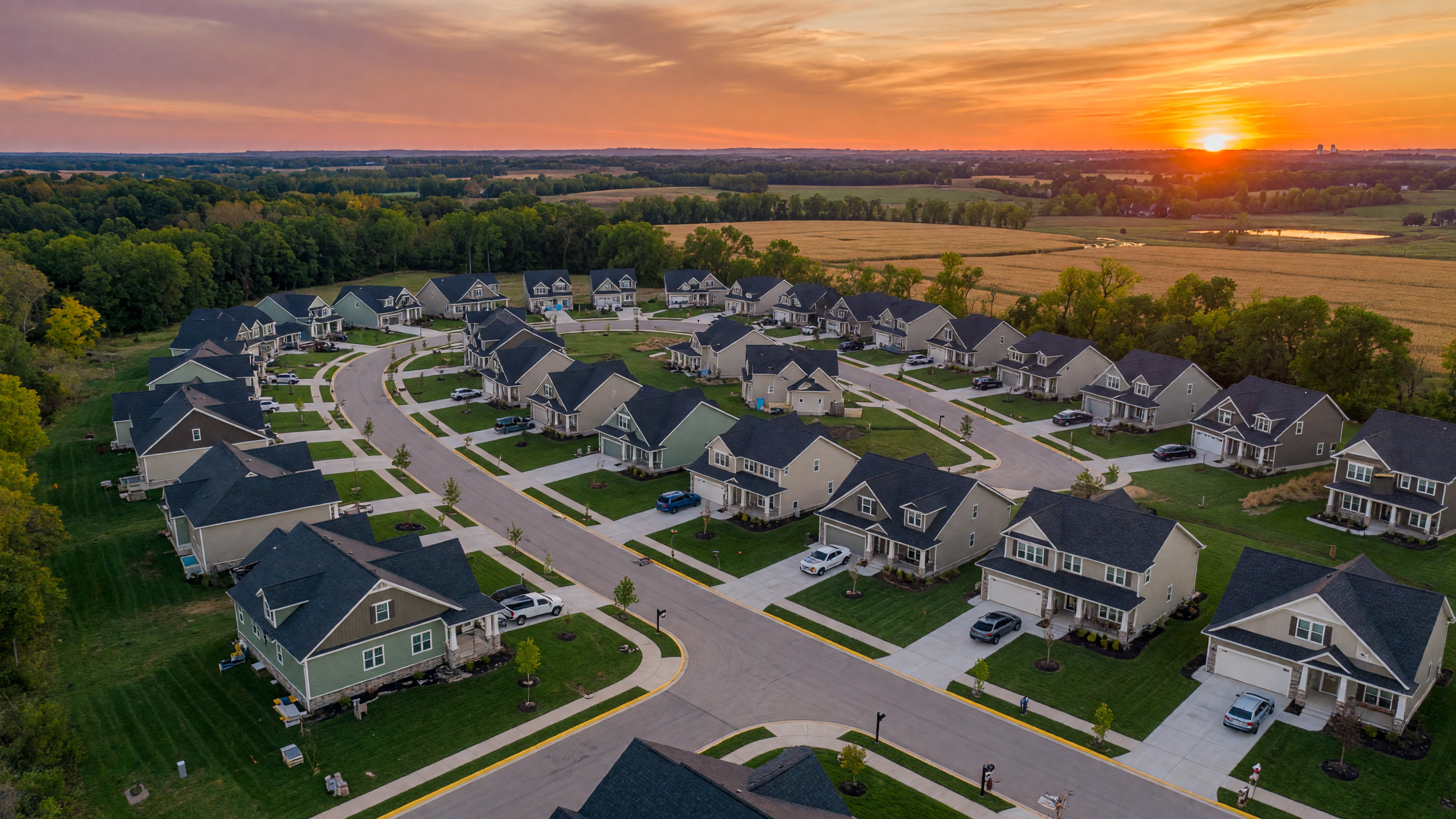Aerial view of new construction homes in a southeastern Michigan community at golden hour