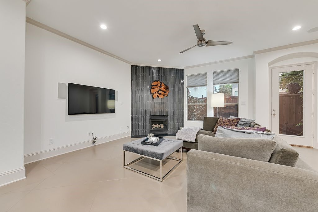 Living room with stained concrete floors and floor-to-ceiling tile fireplace