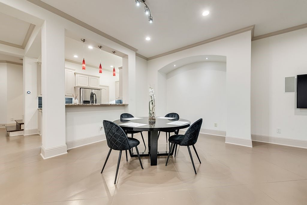 Dining room with stained concrete flooring and view toward the kitchen