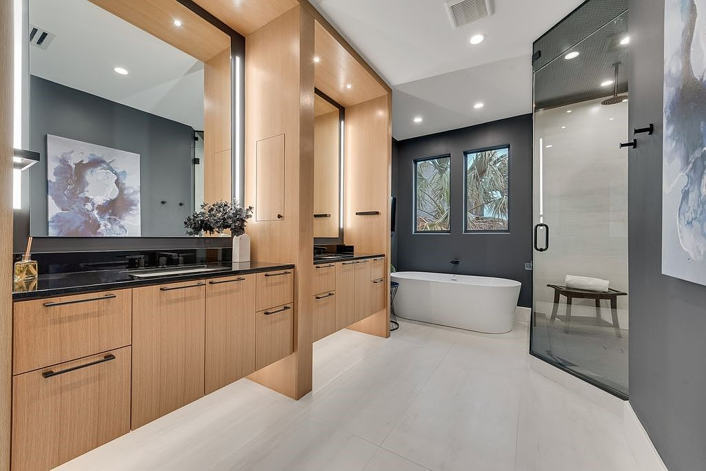 Primary bathroom with freestanding tub, double vanities, and glass steam shower