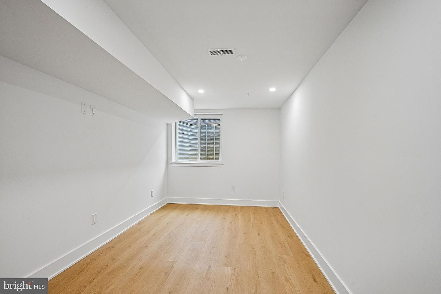 Fully finished basement level suite with custom flooring and clean drywall finishes