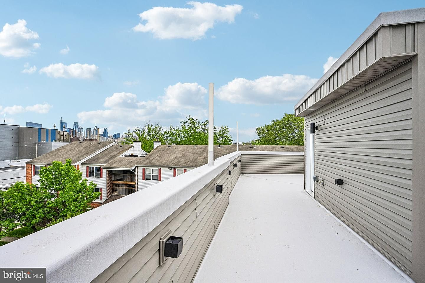 Expansive private rooftop deck showing clear views of the distant Philadelphia skyline