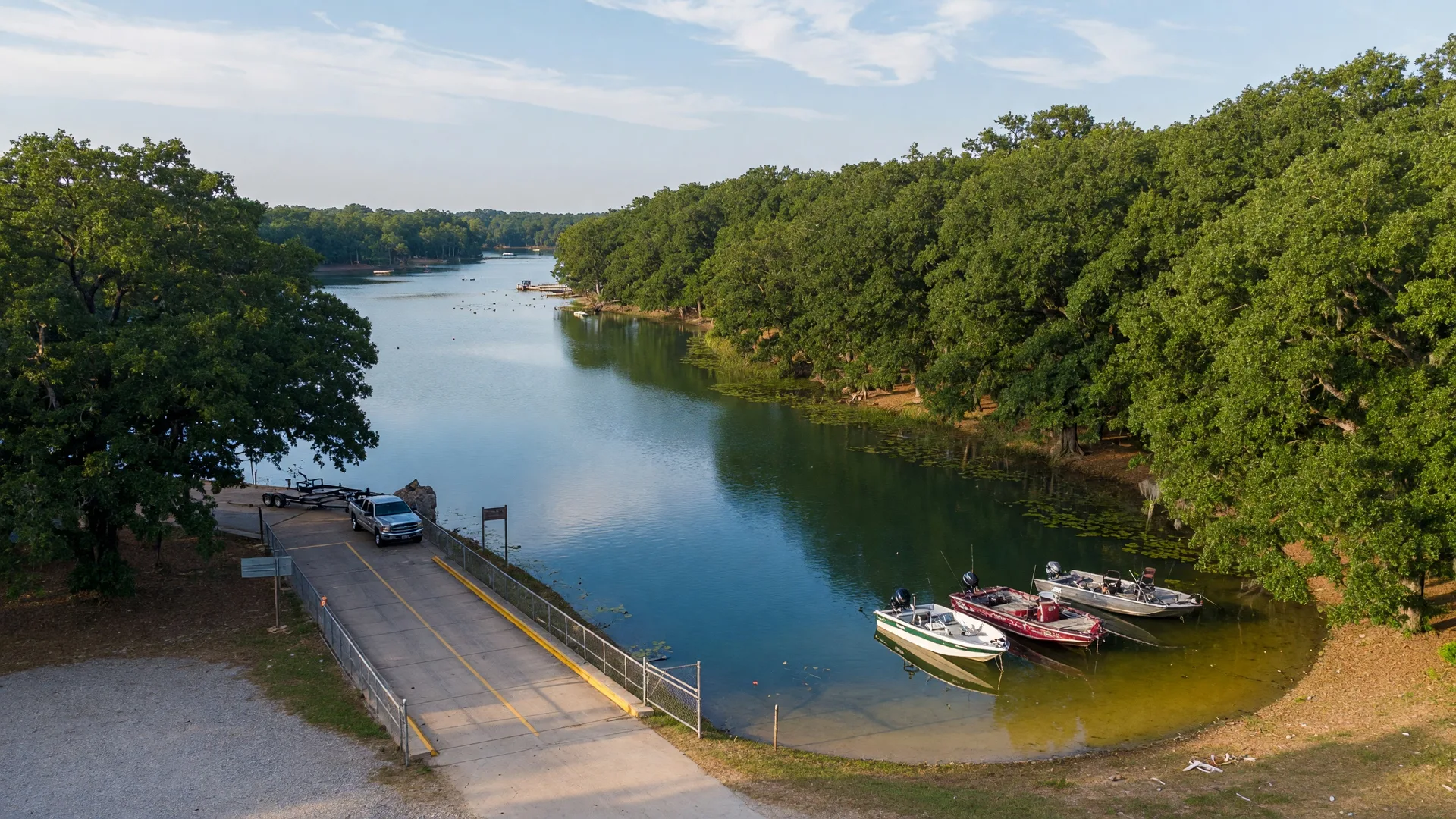 Recreational trail winding through North Texas landscape with wildflowers and a lake visible in the background