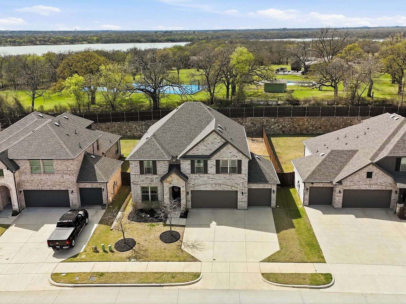 Aerial drone view of Sycamore Cove homes with Lake Lewisville visible in the background