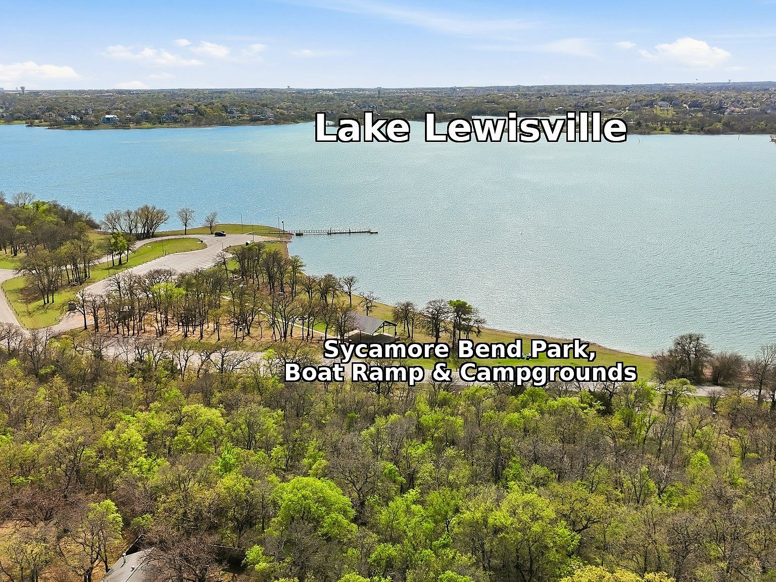 Aerial view of Lake Lewisville and Sycamore Bend Park with boat ramp and green tree canopy