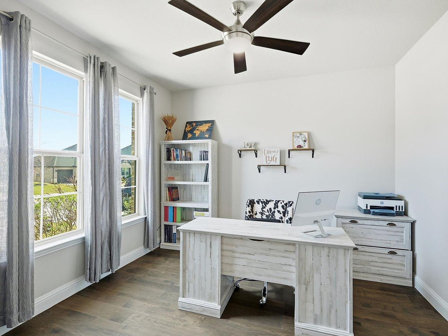 Dedicated home office with white furniture and natural daylight