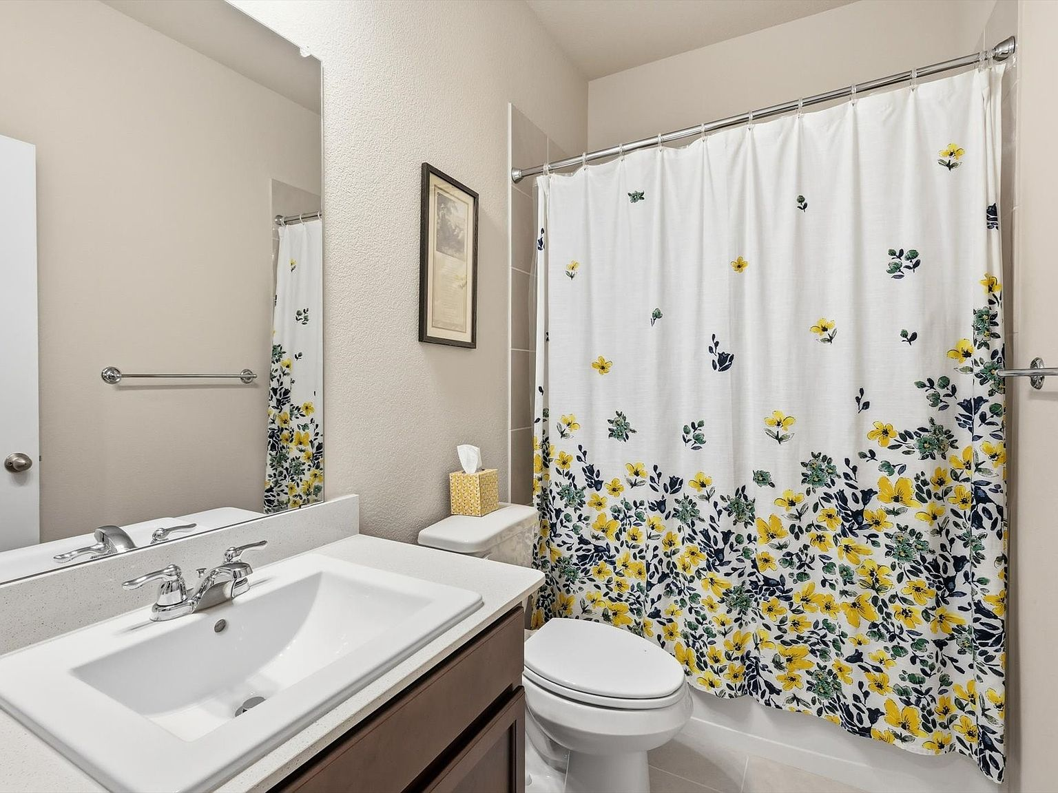 Secondary bathroom with dark wood vanity and chrome fixtures