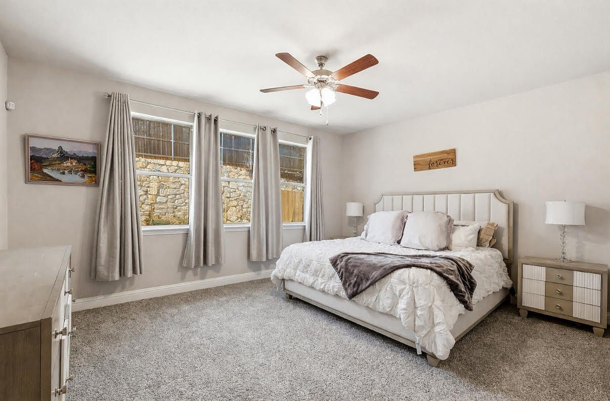Primary bedroom with large windows and natural light