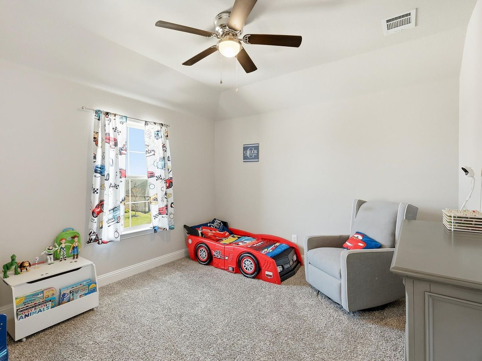 Child bedroom with racecar bed and car-themed decor